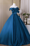 Blue evening gown on a mannequin against a neutral background