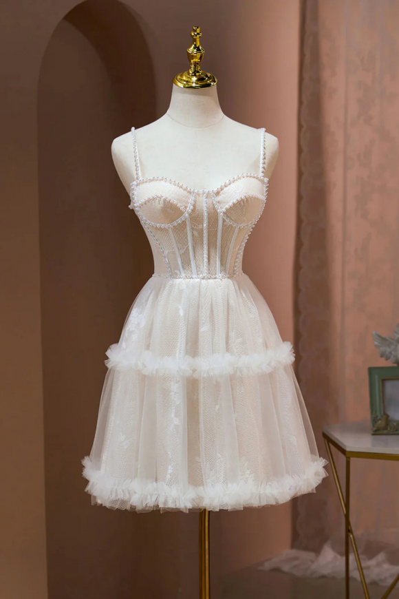 White lace dress on a mannequin against a pink curtain background