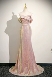 Pink evening gown with gold accents on a mannequin against a white background