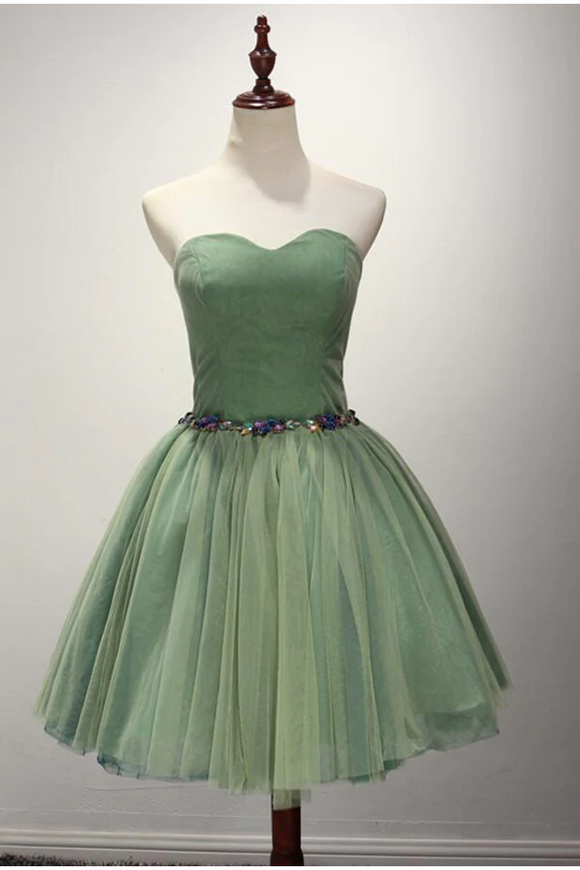 Green strapless dress on a mannequin against a plain background