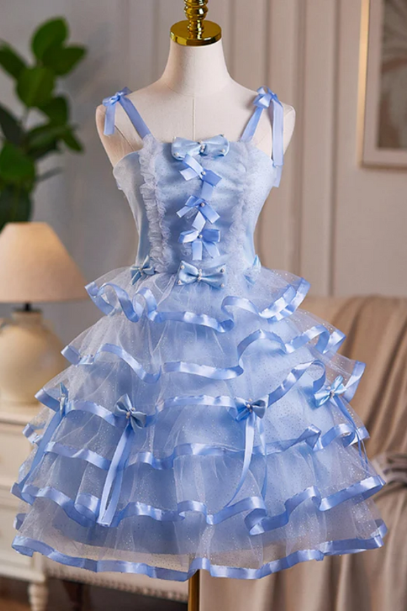 Blue tiered dress with ribbon details on a mannequin against a neutral background