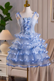 Blue tiered dress with bow details on a mannequin against a home interior background