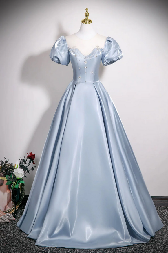 Light blue evening gown on a mannequin against a plain background