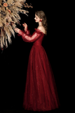 Woman in a red evening gown against a black background