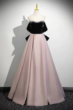 Black top and pink skirt dress on a mannequin against a white background