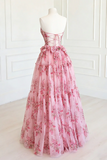 Pink floral dress on a mannequin against a white wall