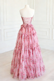 Pink floral dress on a mannequin against a white wall