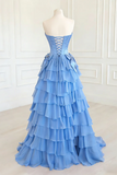 Blue tiered dress on a mannequin against a white wall.