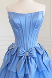 Blue strapless dress with a large bow on a mannequin against a white background