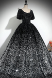 Black sequin evening gown on a mannequin against a neutral background