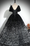 Black sequin evening gown on a mannequin against a neutral background