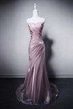 Pink evening gown on a mannequin against a gray background