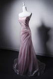 Pink evening gown on a mannequin against a plain background