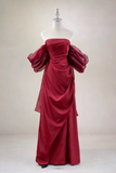 Red evening gown on a mannequin against a plain background
