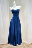 Blue evening gown on a mannequin against a white curtain background