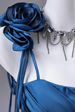 Blue rose accessory on a white dress with silver necklace