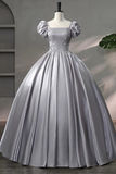 Silver ball gown on a mannequin against a neutral background