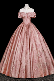 Pink vintage gown on a mannequin against a black background