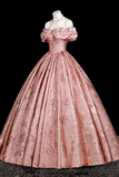 Pink ball gown on a mannequin against a black background
