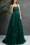 Green evening gown with floral embroidery on a gray background