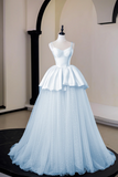 Light blue evening gown on a mannequin against a neutral background