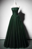 Green evening gown on a mannequin against a plain background
