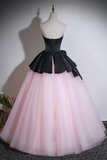 Black and pink ball gown on a mannequin against a plain background