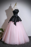 Black and pink dress on a mannequin against a plain background