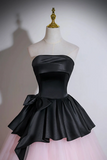 Black strapless top with a large bow and pink skirt on a mannequin against a white background
