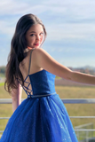 Woman in a blue dress with a scenic background
