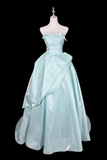 Light blue evening gown on a mannequin against a black background