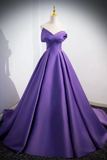 Purple evening gown on a mannequin against a plain background