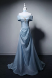 Blue evening gown on a mannequin against a gray background