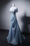 Light blue evening gown on a mannequin against a gray background