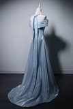 Blue evening gown on a mannequin against a gray background