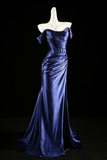 Blue evening gown on a mannequin against a black background