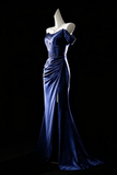 Blue evening gown on a mannequin against a black background