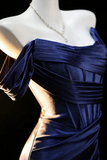 Navy blue strapless dress on a mannequin with a dark background
