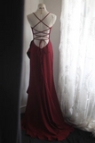 Red evening gown on a mannequin against a white curtain