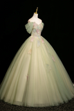 Light green ball gown with floral details on a mannequin against a black background
