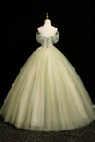 Light green ball gown on a mannequin against a black background