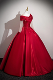 Red ball gown on a mannequin against a plain background