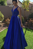 Woman wearing a blue evening gown outdoors on a sunny day.