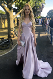 Woman in a lavender evening gown standing outdoors on a sunny day.