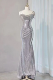 Silver sequin evening gown on a mannequin against a white curtain background