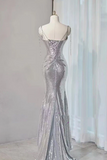 Silver sequin evening gown on a mannequin against a white curtain background