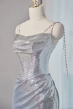 Silver sequin dress on a mannequin against a neutral background