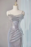 Silver sequin dress on a mannequin against a neutral background