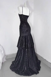 Black sequin evening gown on a mannequin against a white wall.