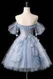 Light blue dress with floral details on a mannequin against a black background